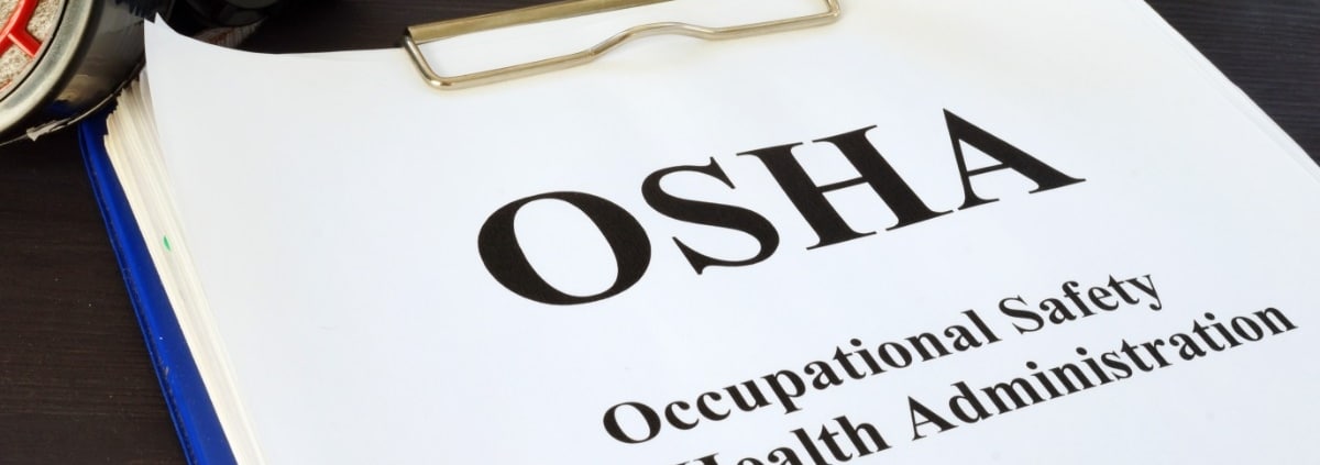 A close-up of a white paper attached to a clipboard that reads "OSHA" and "Occupational Safety and Health Administration."