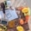 An overhead view of three construction workers in hard hats and vests leaning on a wooden table and discussing plans.